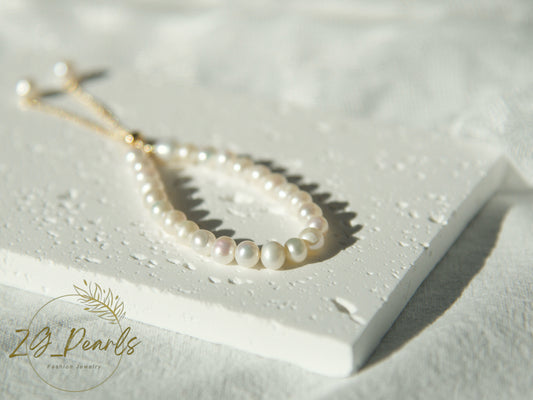 Pearl necklace on a white surface with 'Zg Pearls' branding.