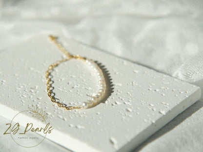 Pearl bracelet on a textured white surface with 'ZL Pearls' branding.