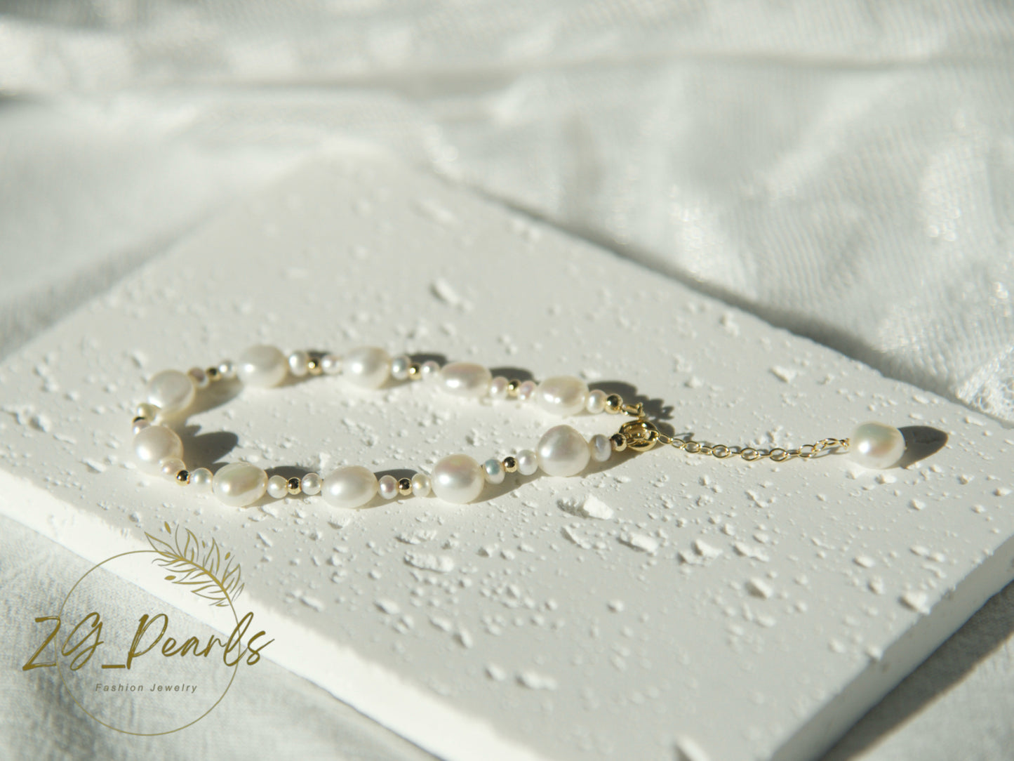 Pearl bracelet on a light surface with 'Zg Pearls' branding.