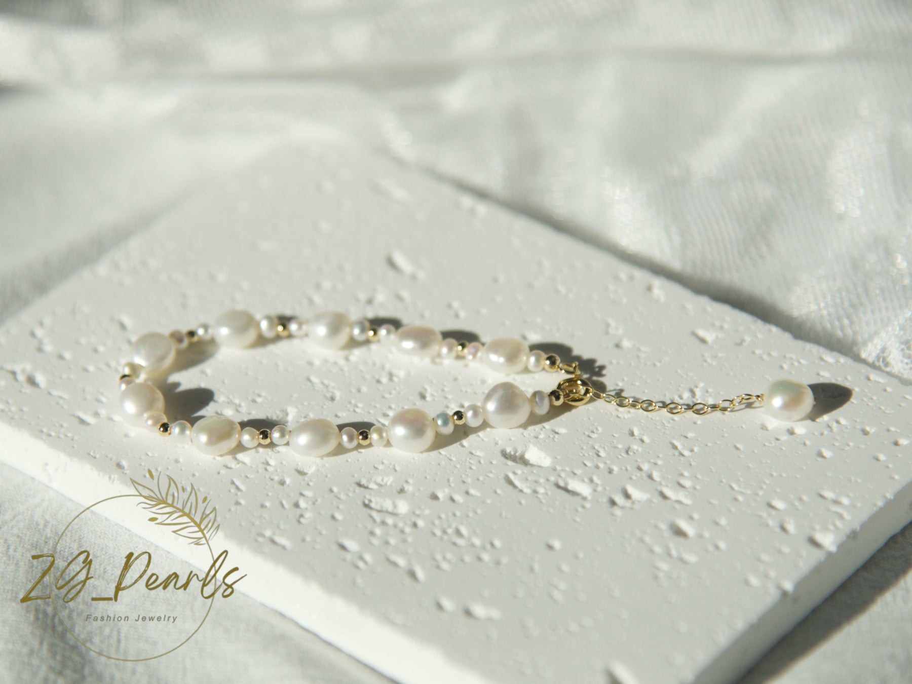 Pearl bracelet on a light surface with 'Zg Pearls' branding.