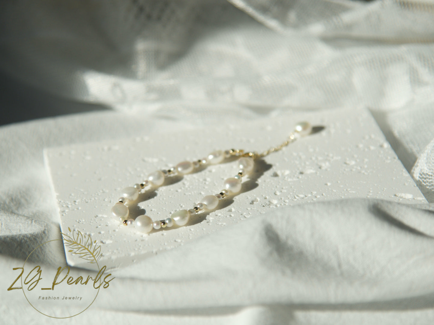 Pearl necklace on a white card with 'Zg Pearls' branding on a white fabric background
