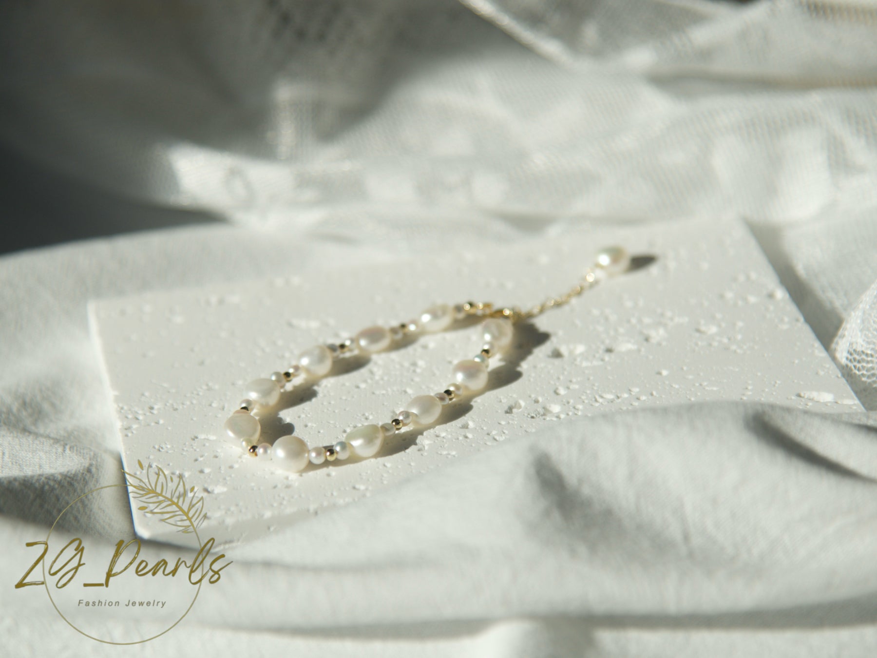 Pearl necklace on a white card with 'Zg Pearls' branding on a white fabric background