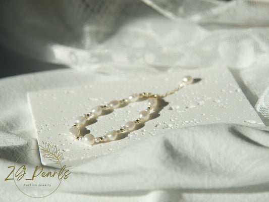 Pearl necklace on a white card with 'Zg Pearls' branding on a white fabric background