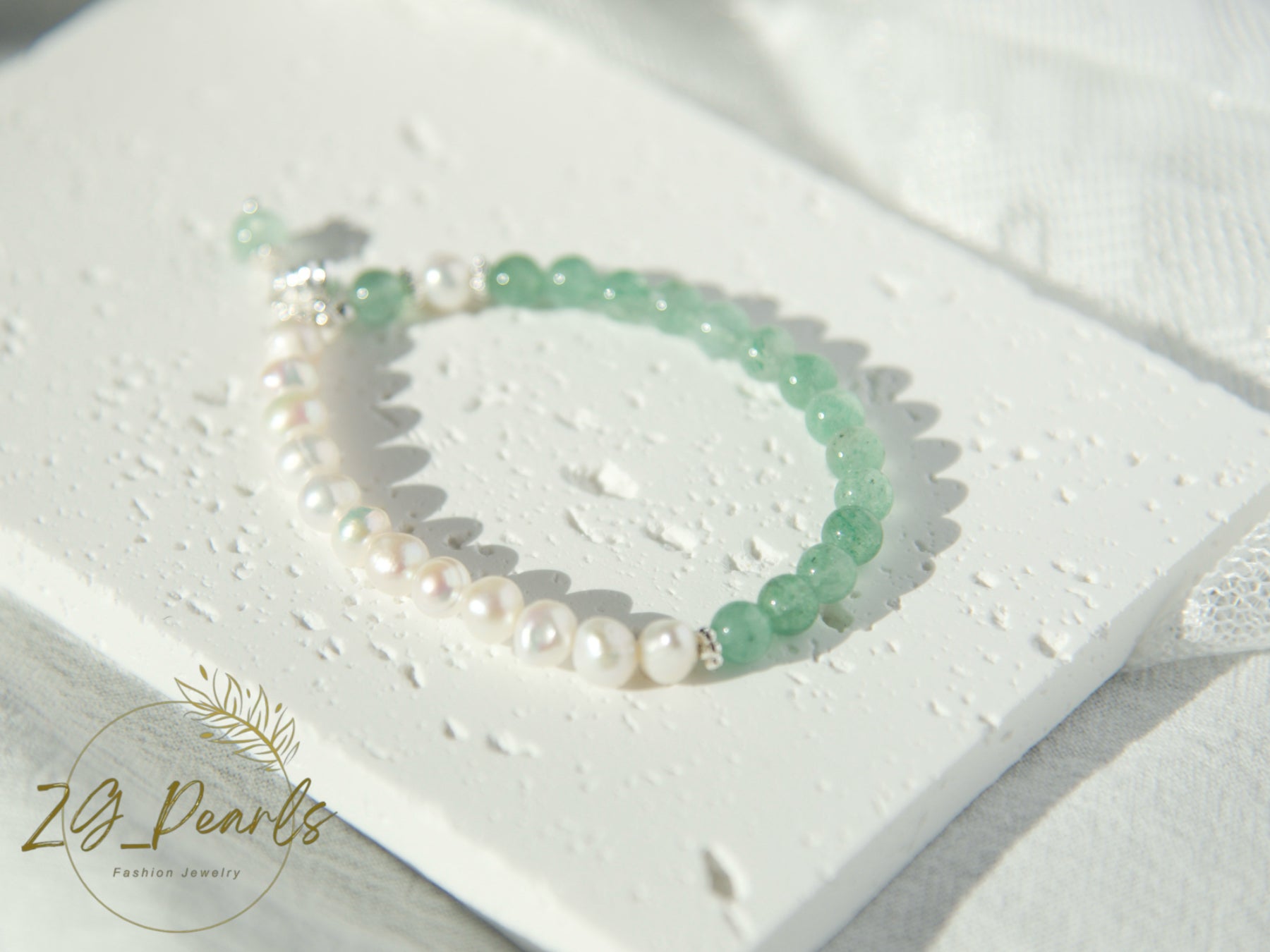 Pearl and green bead bracelet on a white heart-shaped card with 'ZG Pearls' branding.