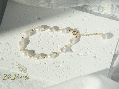 Pearl bracelet on a textured white surface with a soft light background