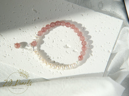 Beaded bracelet with pink and white beads on a textured white surface, Zg Jewelry logo visible.