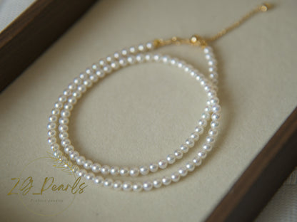 Pearl necklace on a beige surface with 'ZG Pearls' branding.