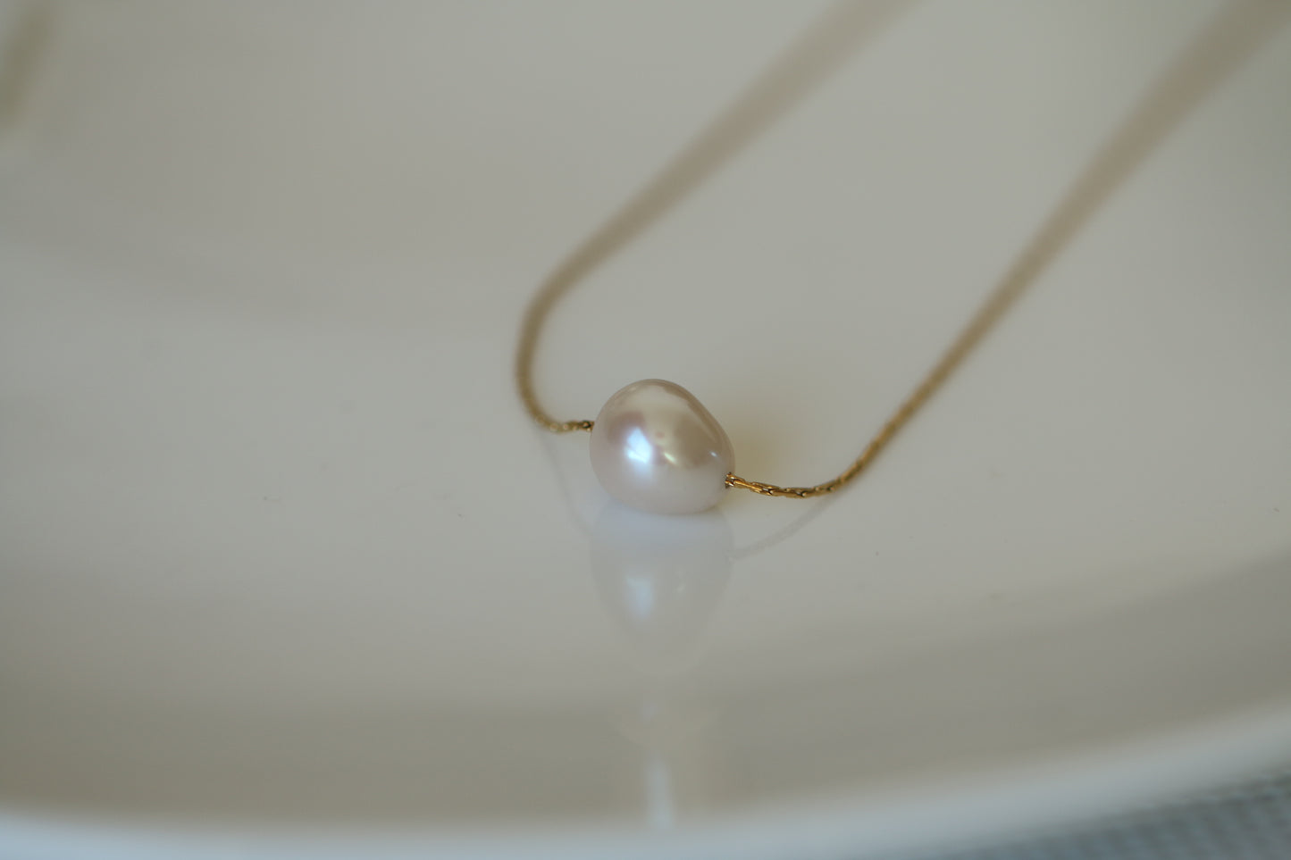 Pearl necklace on a white surface